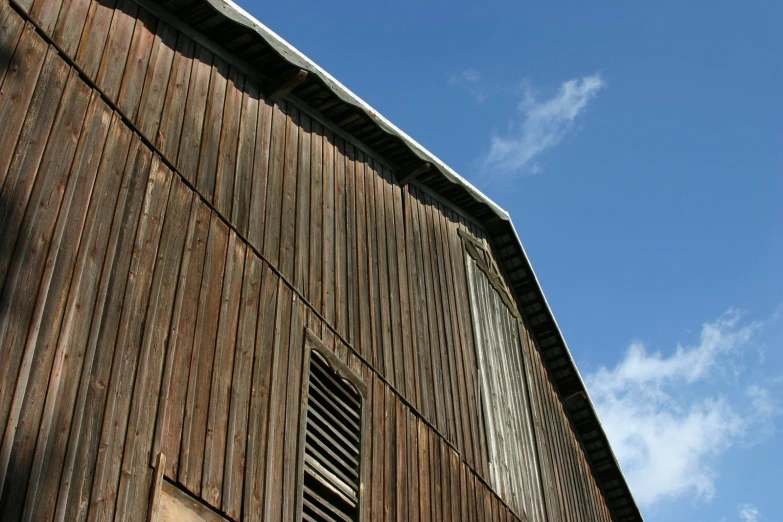 a red wooden building with a white clock