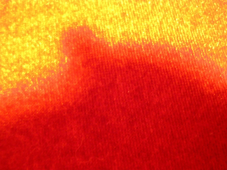 the back of a black object with light orange and red colors