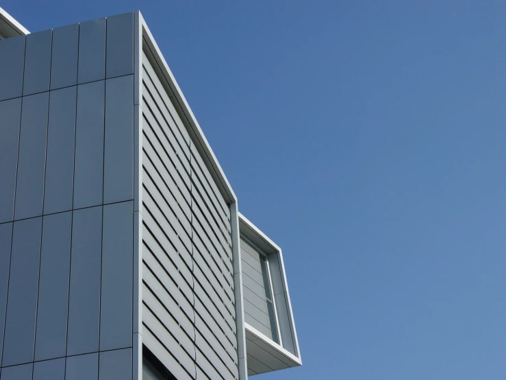 a close up of a building with a bird flying in the background