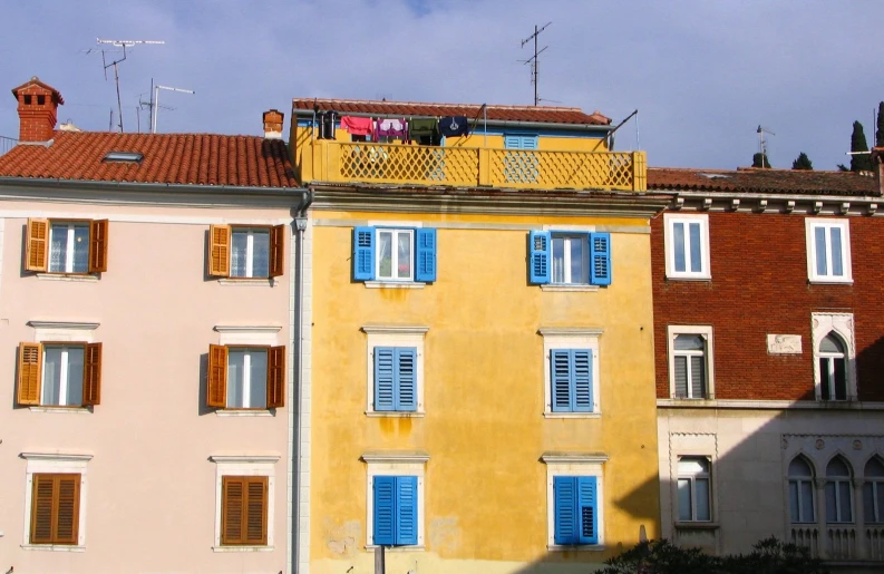 the building has shutters that make it appear like windows are painted blue