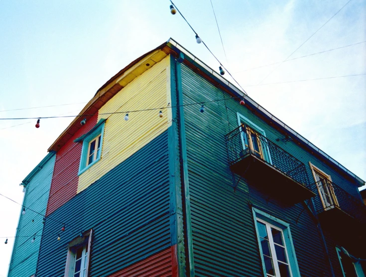 blue, yellow, and red house with two stories