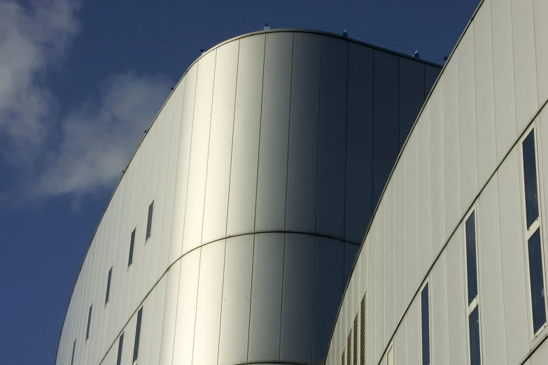 a large metal building against the blue sky