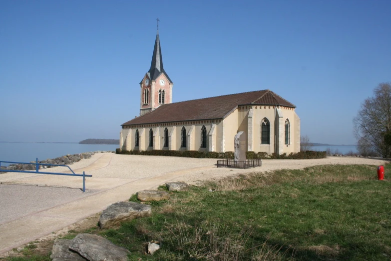 a church and water front with a red post