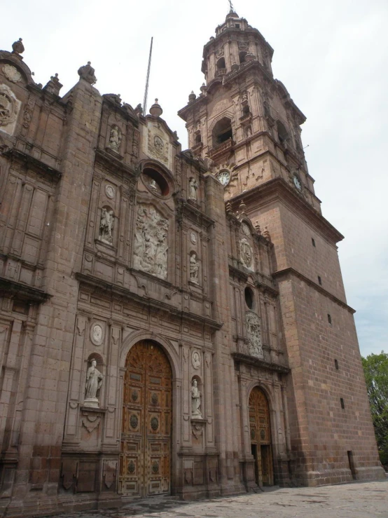 a church that is tall with an ornate clock