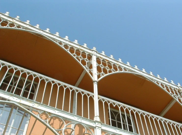 an ornate building with multiple balconies against a blue sky