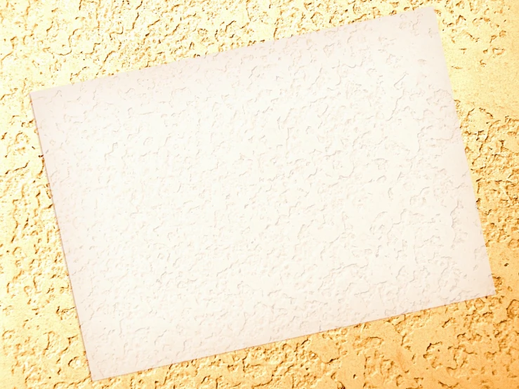 a close up of a white board on a yellow background