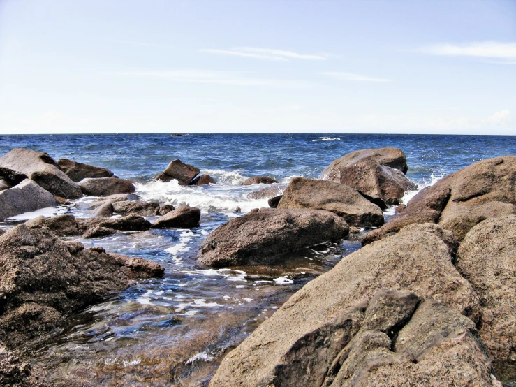 the sea and rocks on the shore look calm
