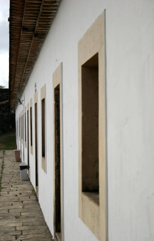 a building that has some windows and brick walkway