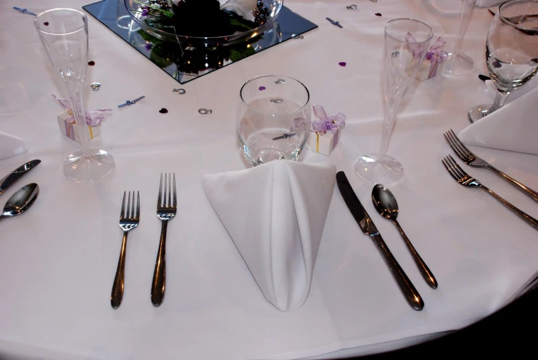 a table topped with lots of shiny silverware