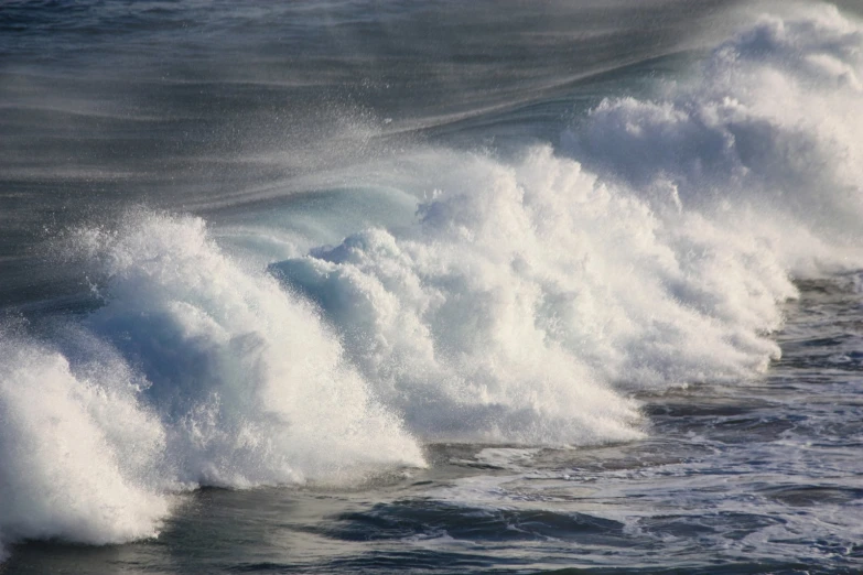 this is a wave with a surfer coming toward shore