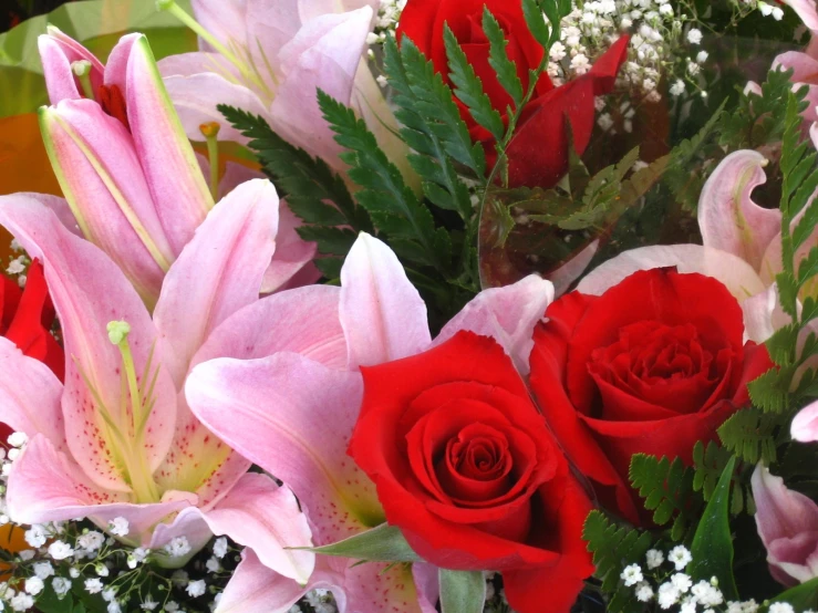 a bouquet of pink and red flowers in a glass vase