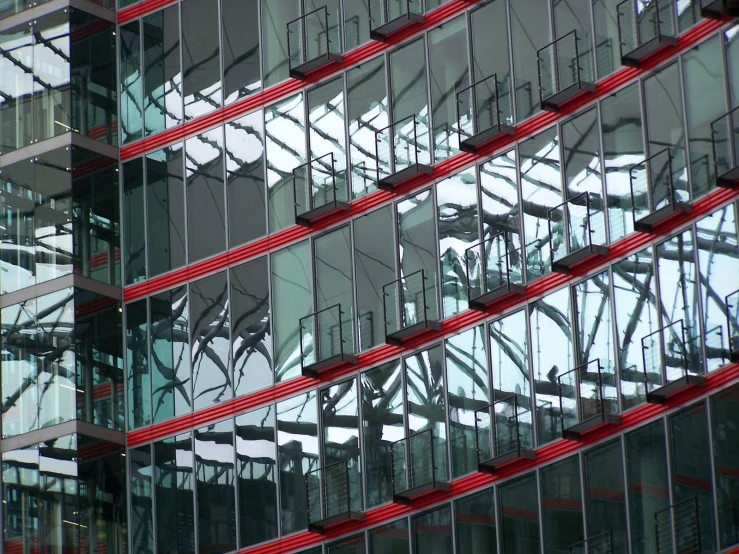 reflection of several skyscrs in the glass windows of another building