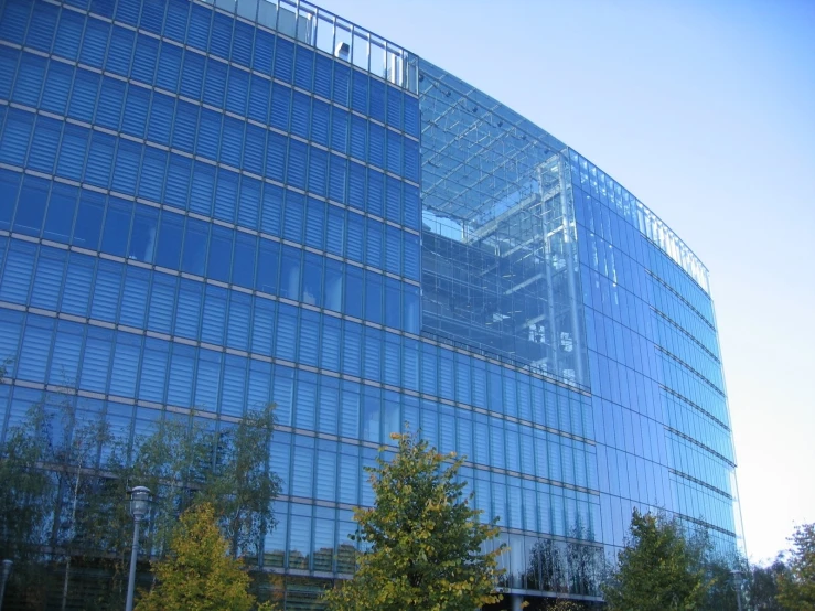 a building with large glass windows and a clock on the side