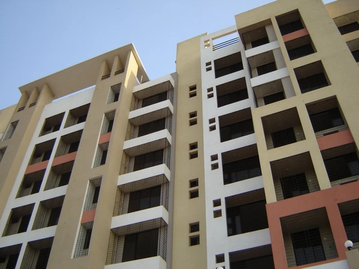 a beige building with lots of windows has small windows