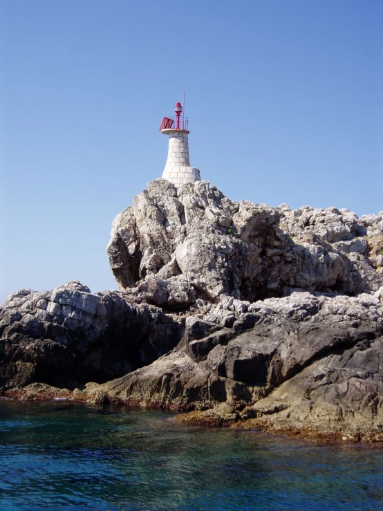 a large light house on top of a rocky island