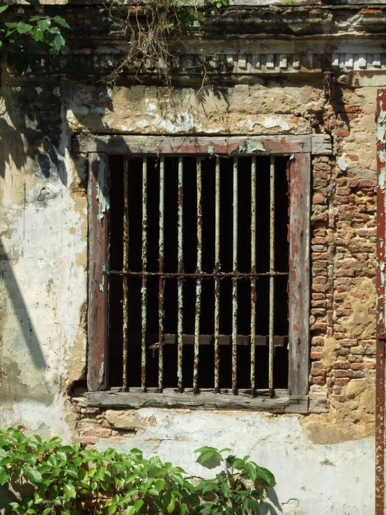 a barred window in an old rundown building