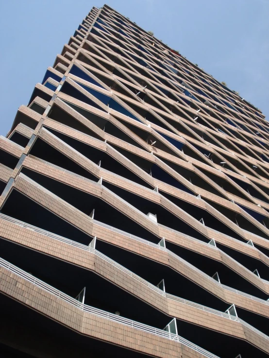 the side of a tall building with a sky background