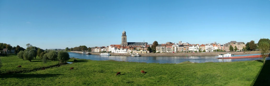 a river surrounded by trees and buildings