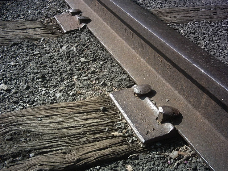 a piece of train tracks sitting on the train tracks