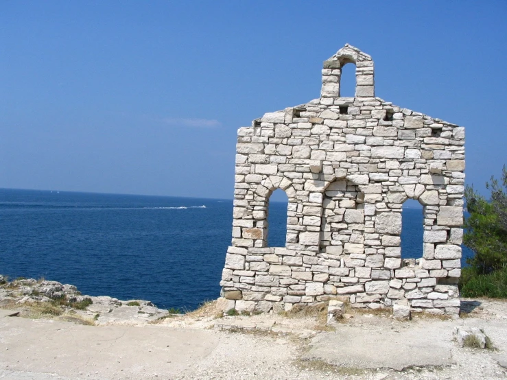 a tower made out of brick near a body of water