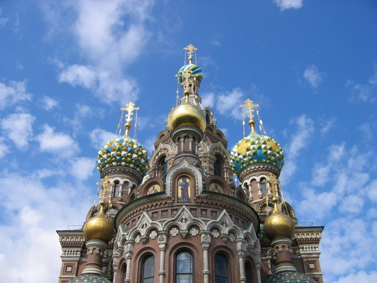 a very tall church with some golden domes