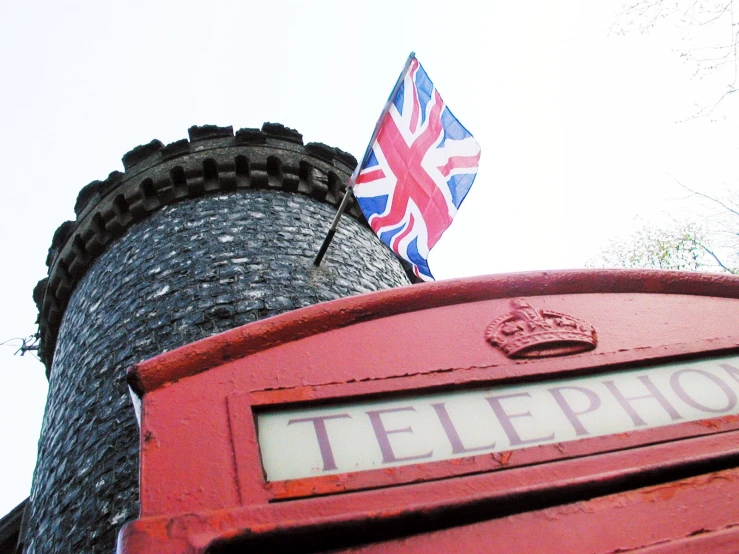the british flag is flown on top of a stone wall