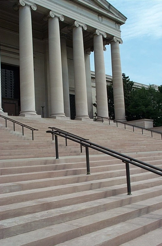 a stone building with three columns that have columns over them