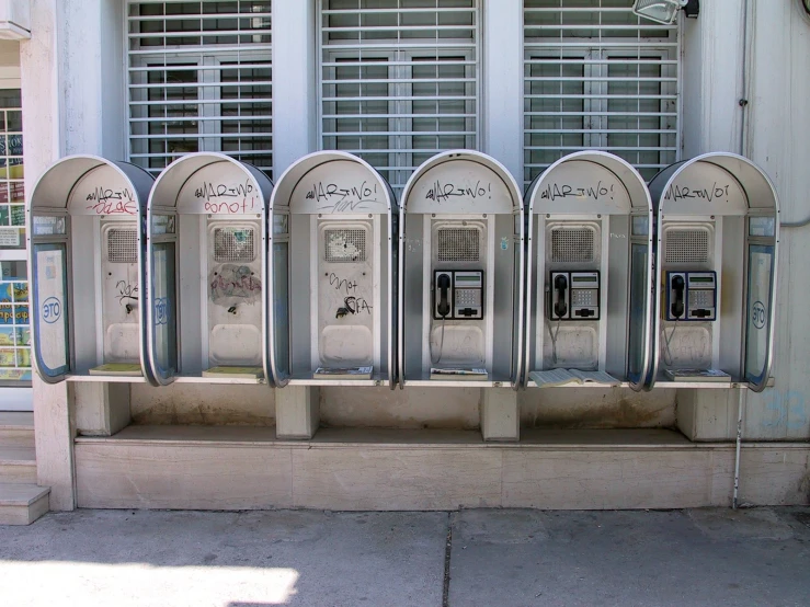 the four parking meters have graffiti on them