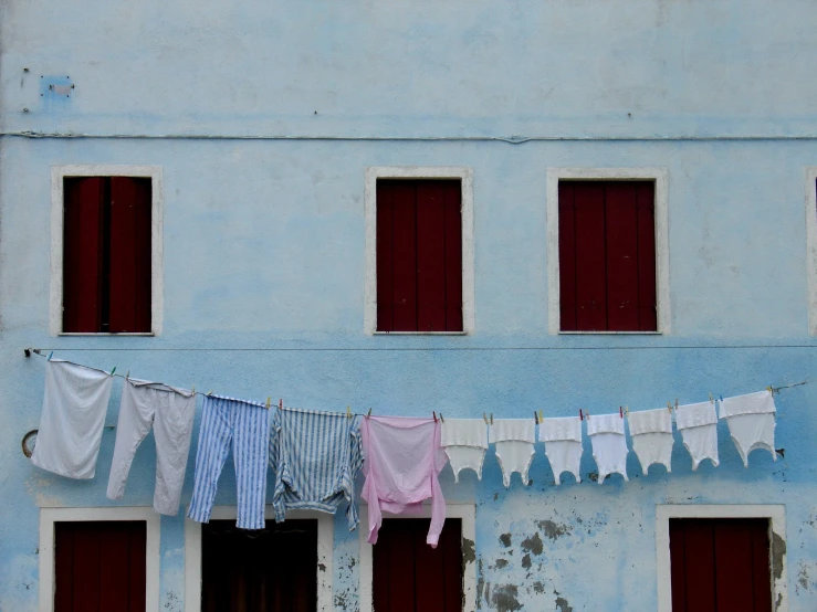 clothes hanging from a rope outside of a building