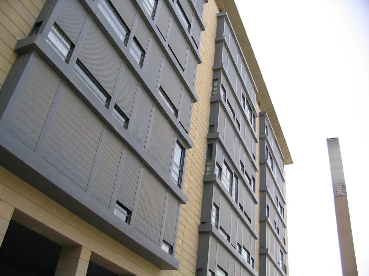 the outside of a building that is yellow and has two levels