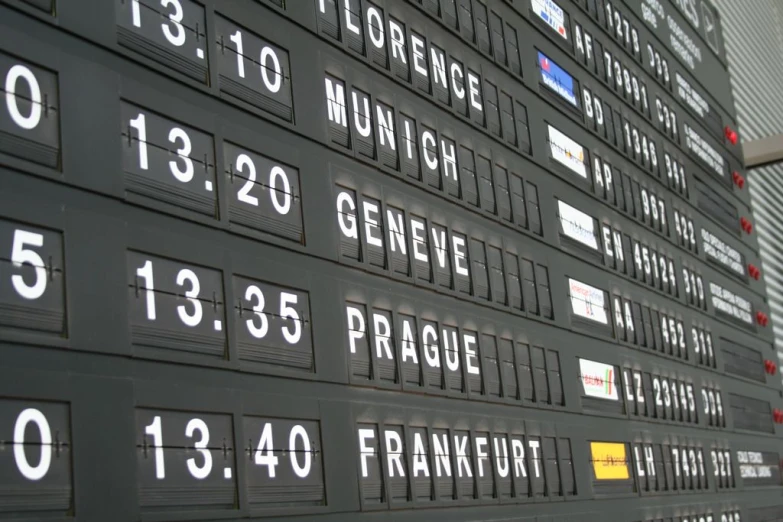 an airport baggage claim board showing the numbers of planes