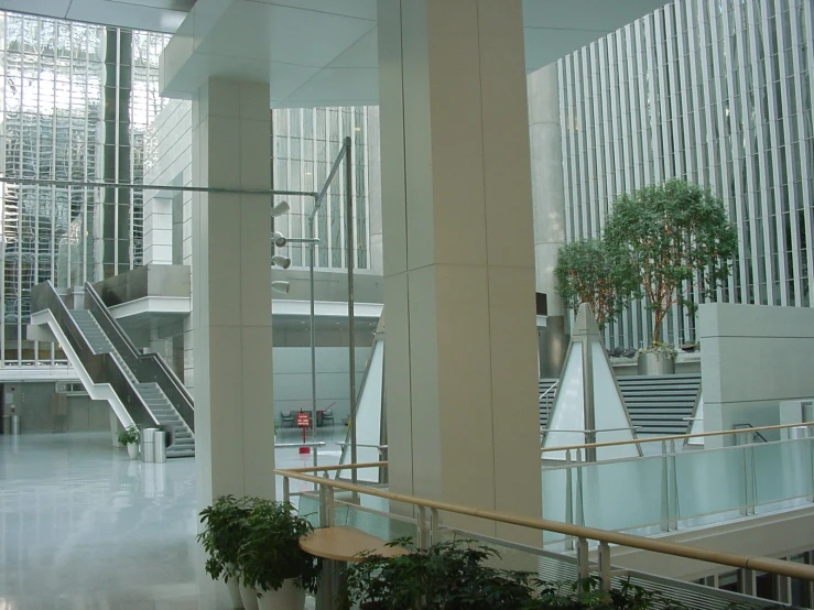 a modern building with stairs and planters in the middle