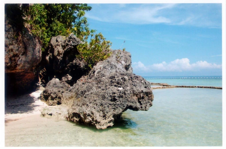 a rock formation in the middle of an ocean