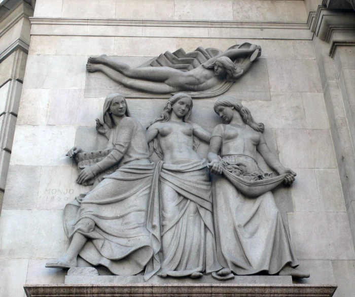 a carving on a building depicts a female figure