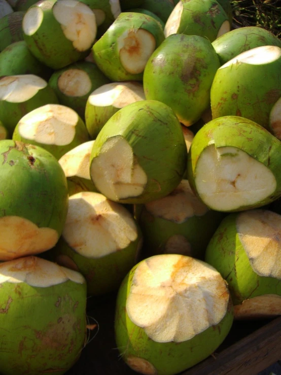 a bunch of freshly picked coconuts sit in a bowl