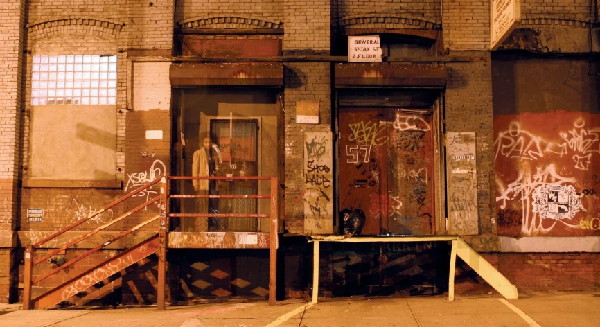 a door in front of a building covered with graffiti