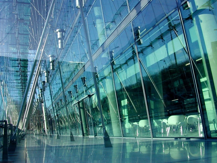 a city that has buildings, street lights and lights, all reflecting off the windows