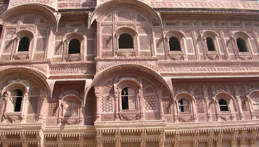 a building has intricate carvings and window frames