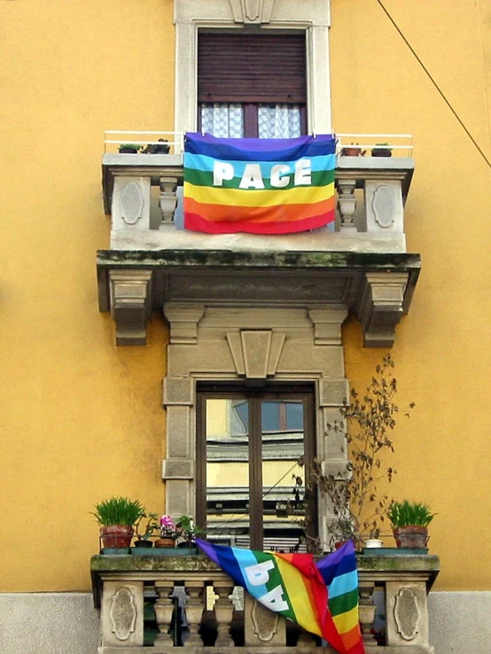 a flag is sitting on the window ledge in front of a building