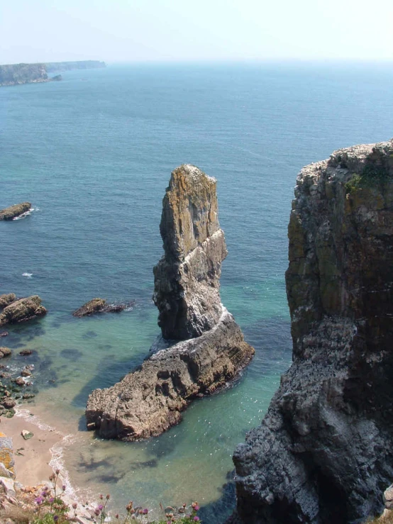 a rock sitting in the middle of the water