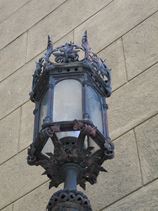 a old - fashioned light with ornate decorations on the top of it