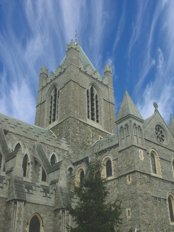 the tall stone church has two towers and windows