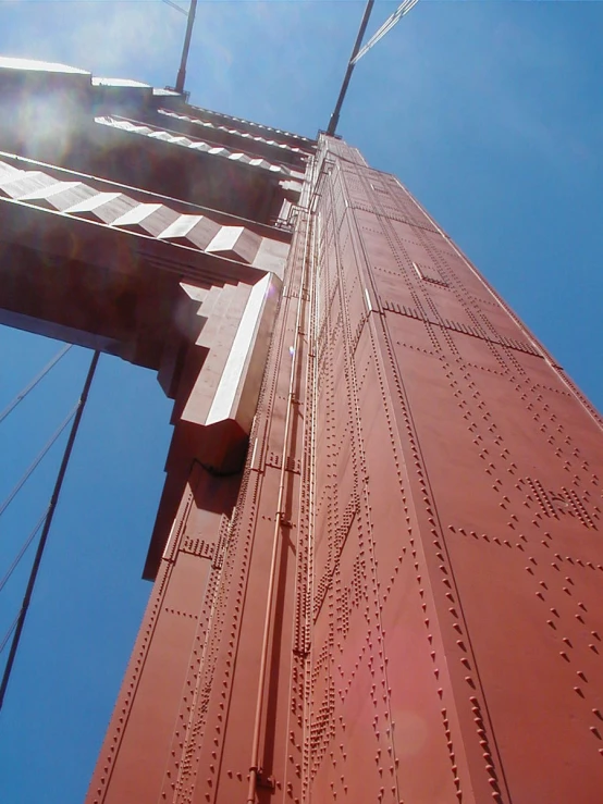 the top portion of the golden gate bridge looking up