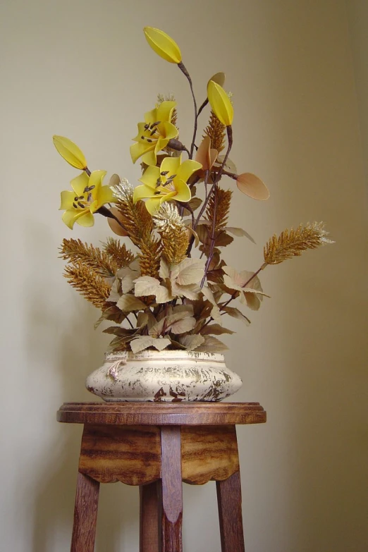 a table with a vase filled with yellow flowers