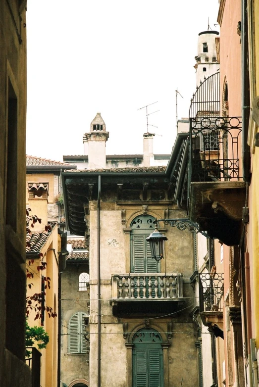 two old buildings with a balcony and balconies next to each other