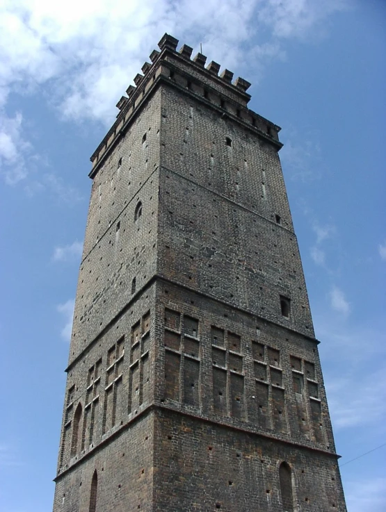 a large brick building has a clock on top