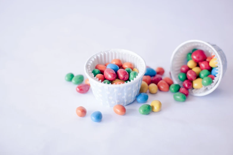 two plastic containers filled with candies and candy