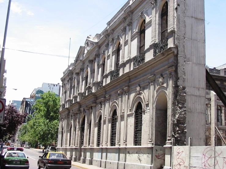 a big old building is being constructed into a concrete wall