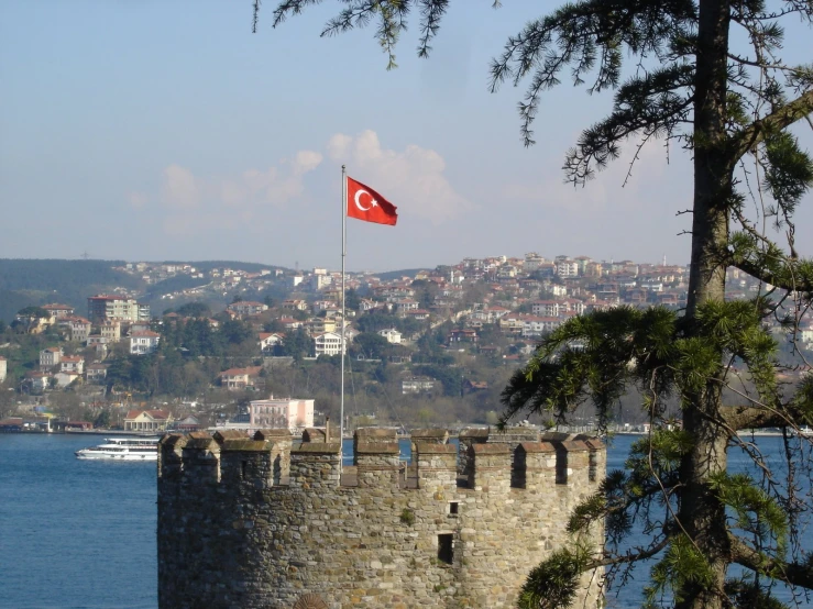 the red flag is on top of a tower