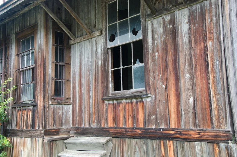 a dilapidated old building with a broken window